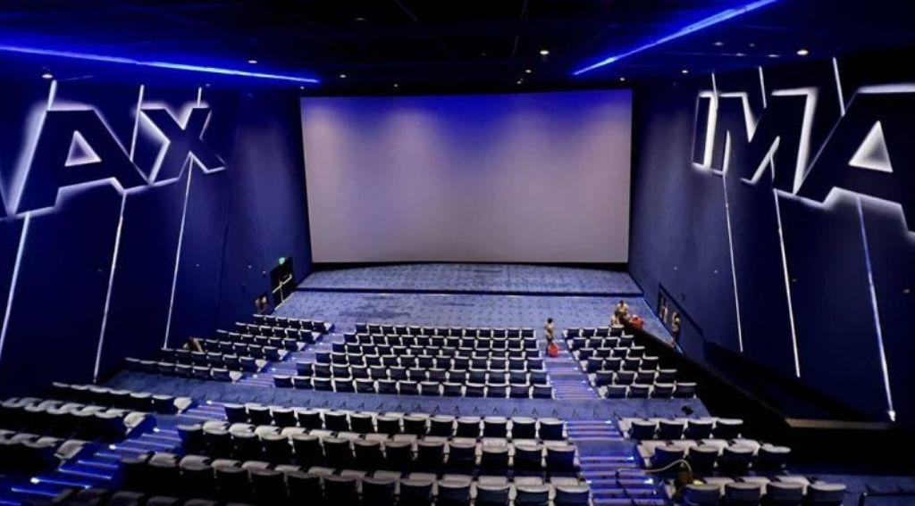 Modern IMAX theater with an audience watching an action movie