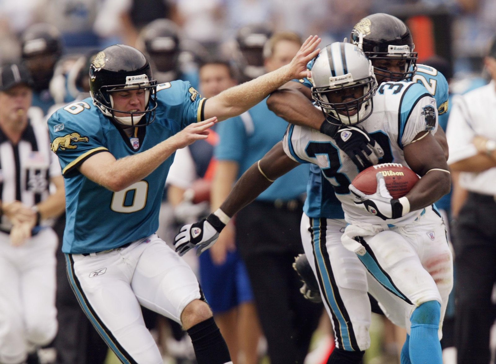 A football player practicing blocking techniques with a training sled