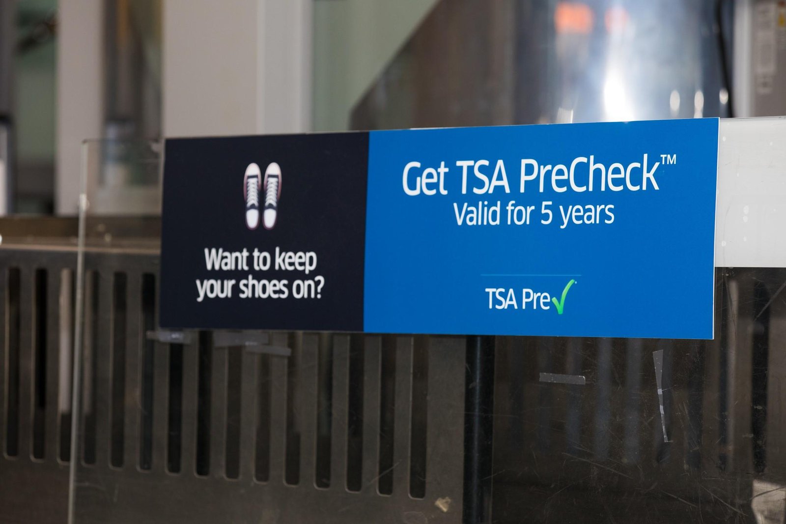 A traveler showing a digital boarding pass with the TSA PreCheck indicator