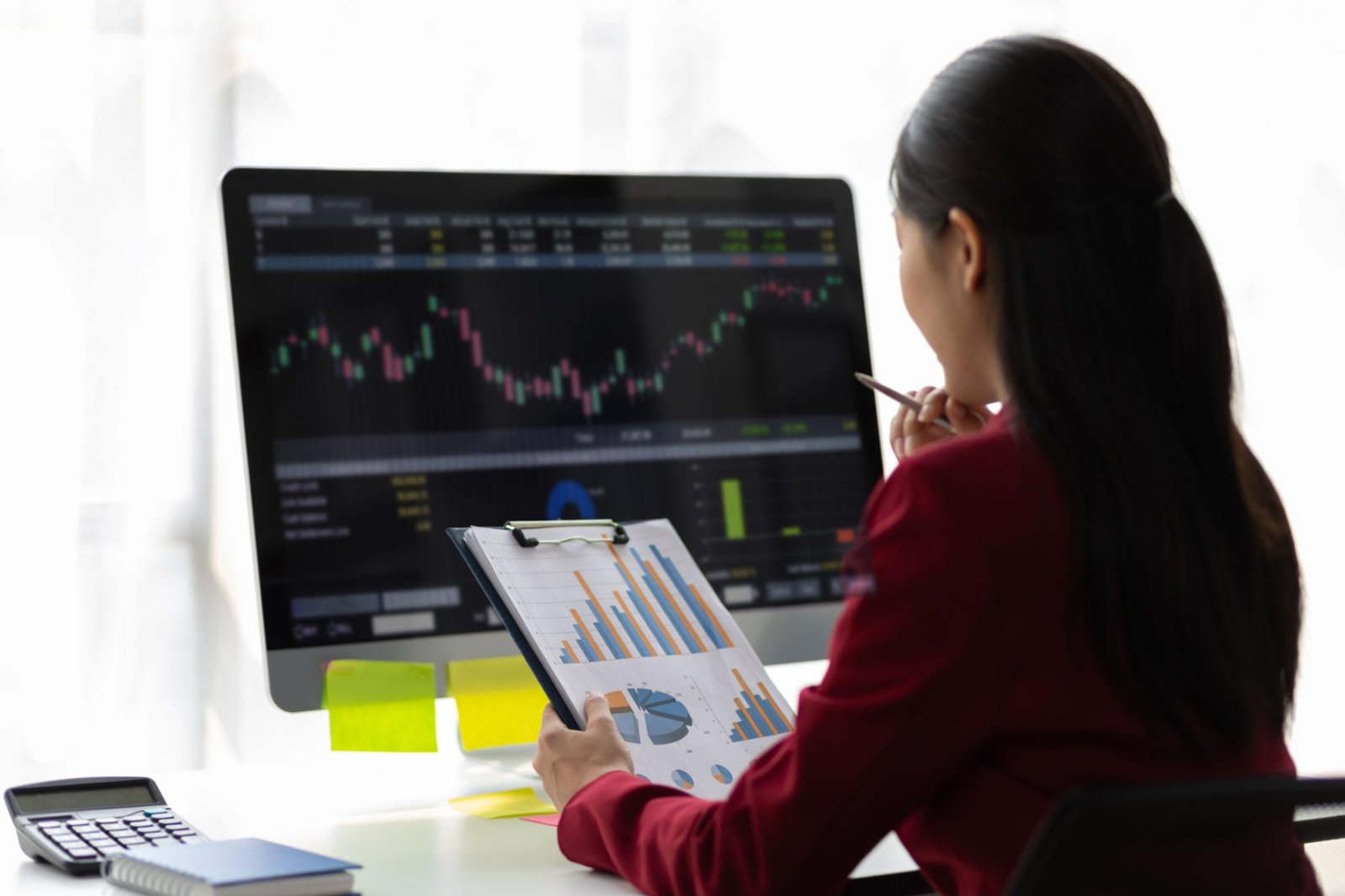 Businesswoman analysis financial data charts and graphs to plan business investment strategies.