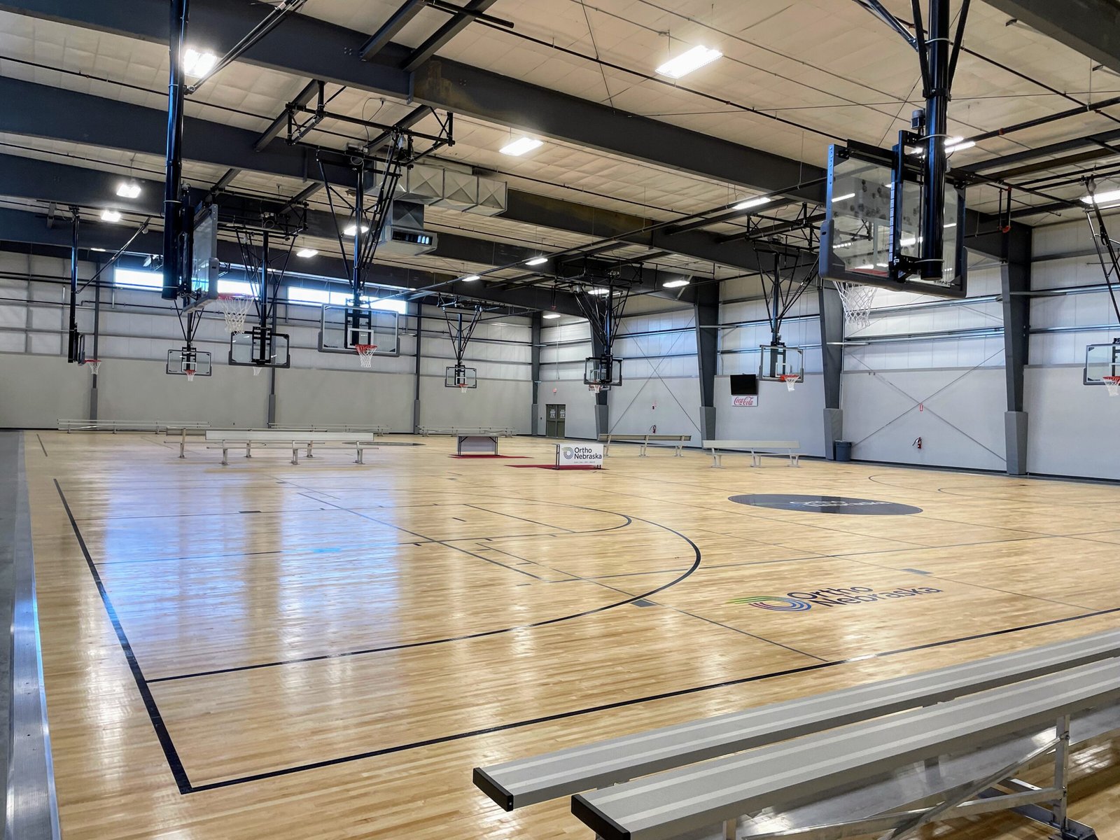 A modern high school basketball training facility with advanced equipment and coaching tools