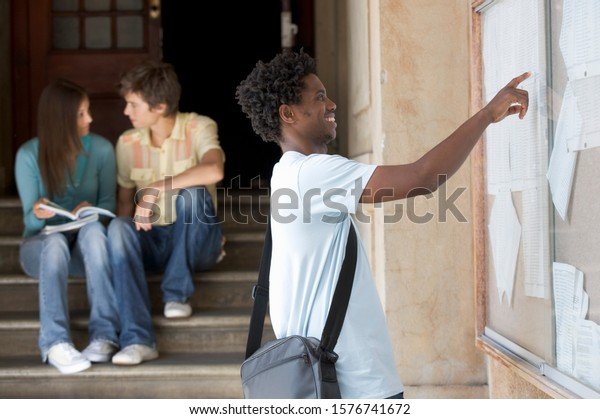 A student checking their examination results online using a laptop