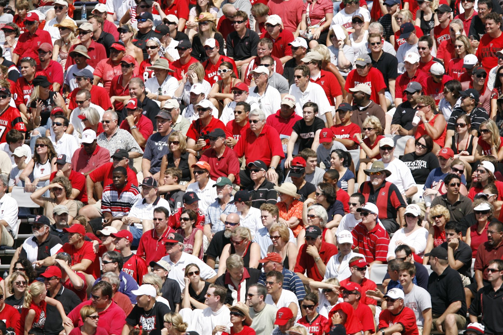 A wide shot of the passionate fan bases in the stands wearing red and blue