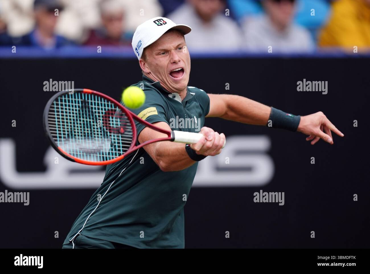 Jenson Brooksby executing a tactical groundstroke during a professional match