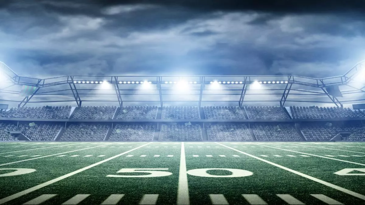 A wide view of a professional football stadium under the lights