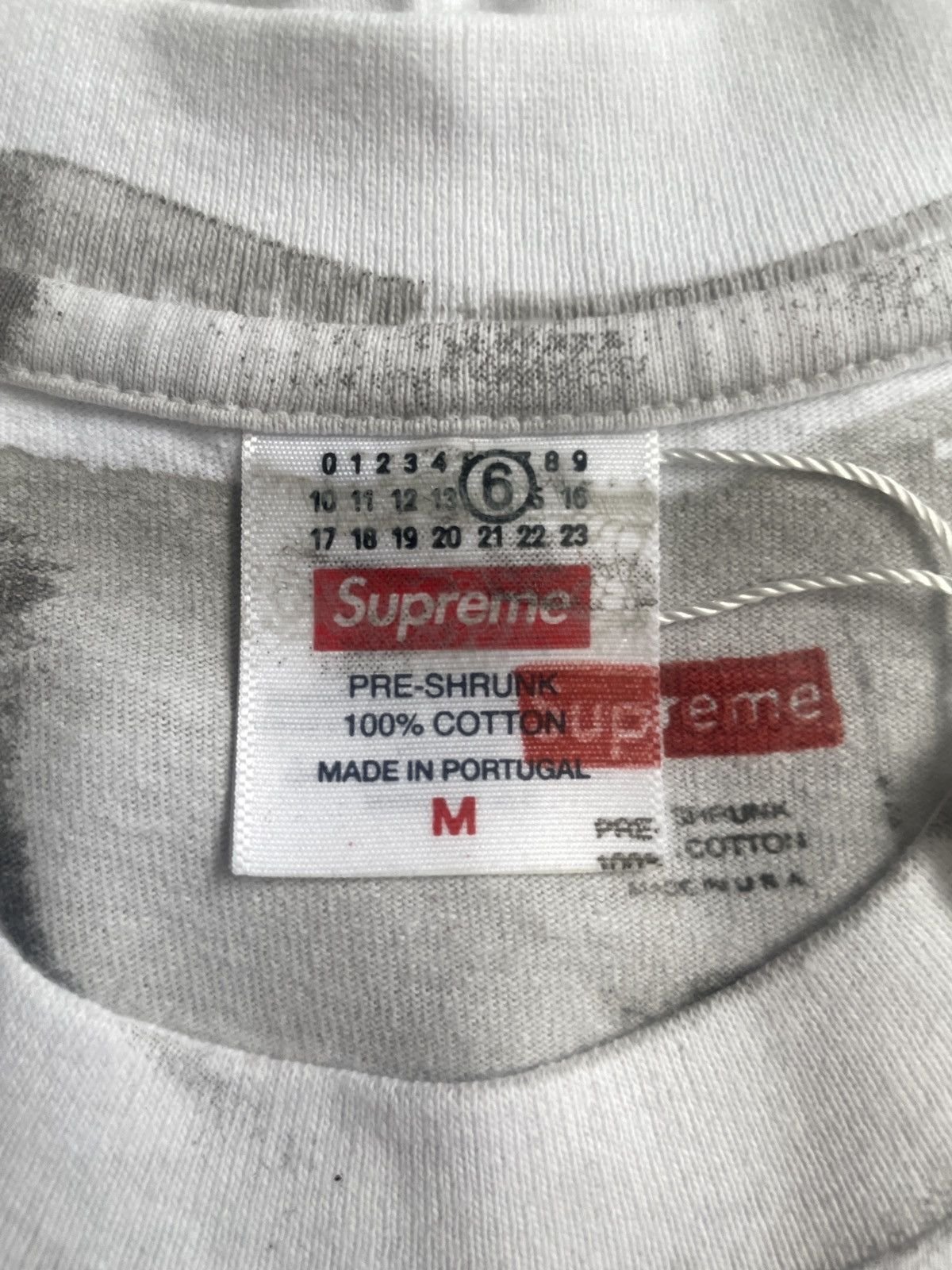 Close up of the Maison Margiela four white stitches and Supreme branding