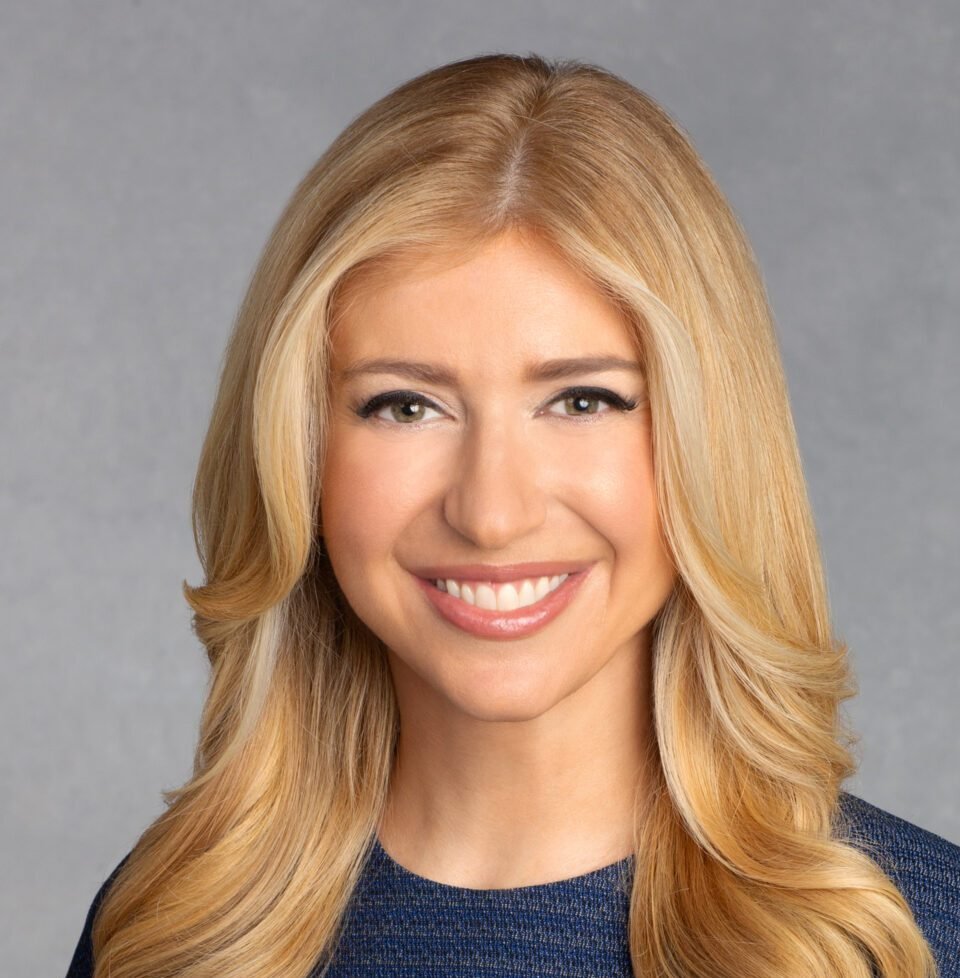 Sara Eisen reporting from a professional financial studio environment